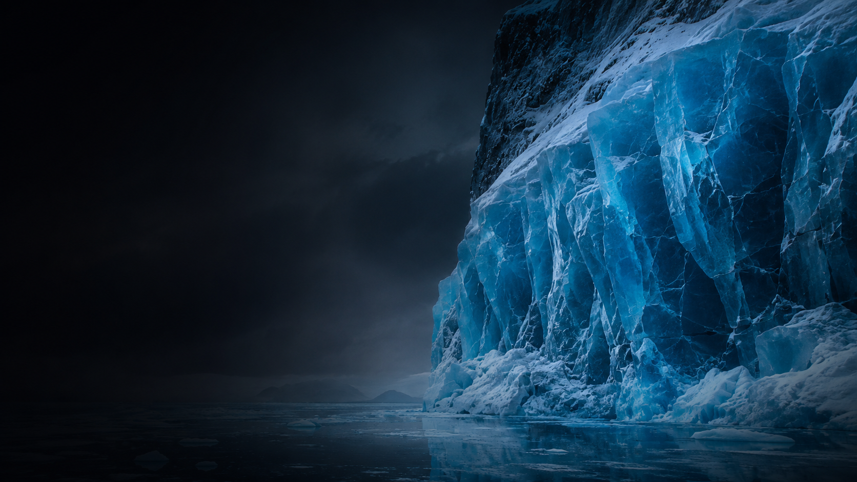 Deep blue glacier ice with white snow and frozen cracks