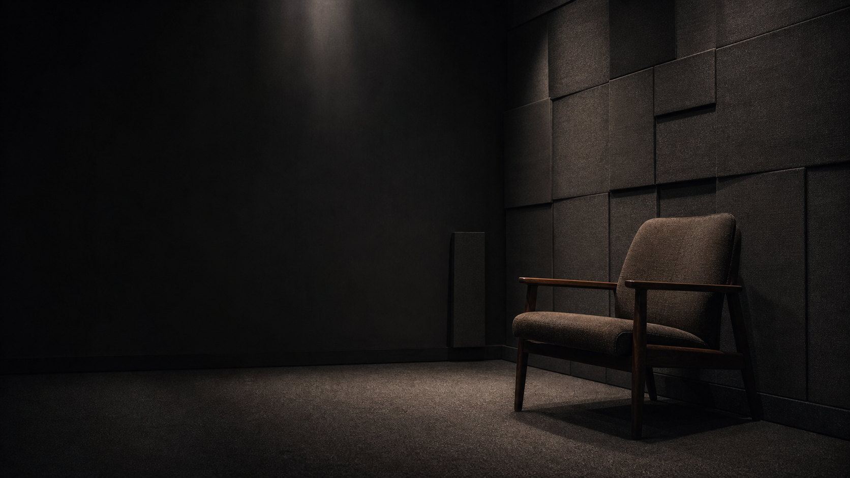 Extremely quiet dark room with soft acoustic surfaces and empty space